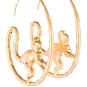 Pair of gold Tory Burch monkey hoop earrings.